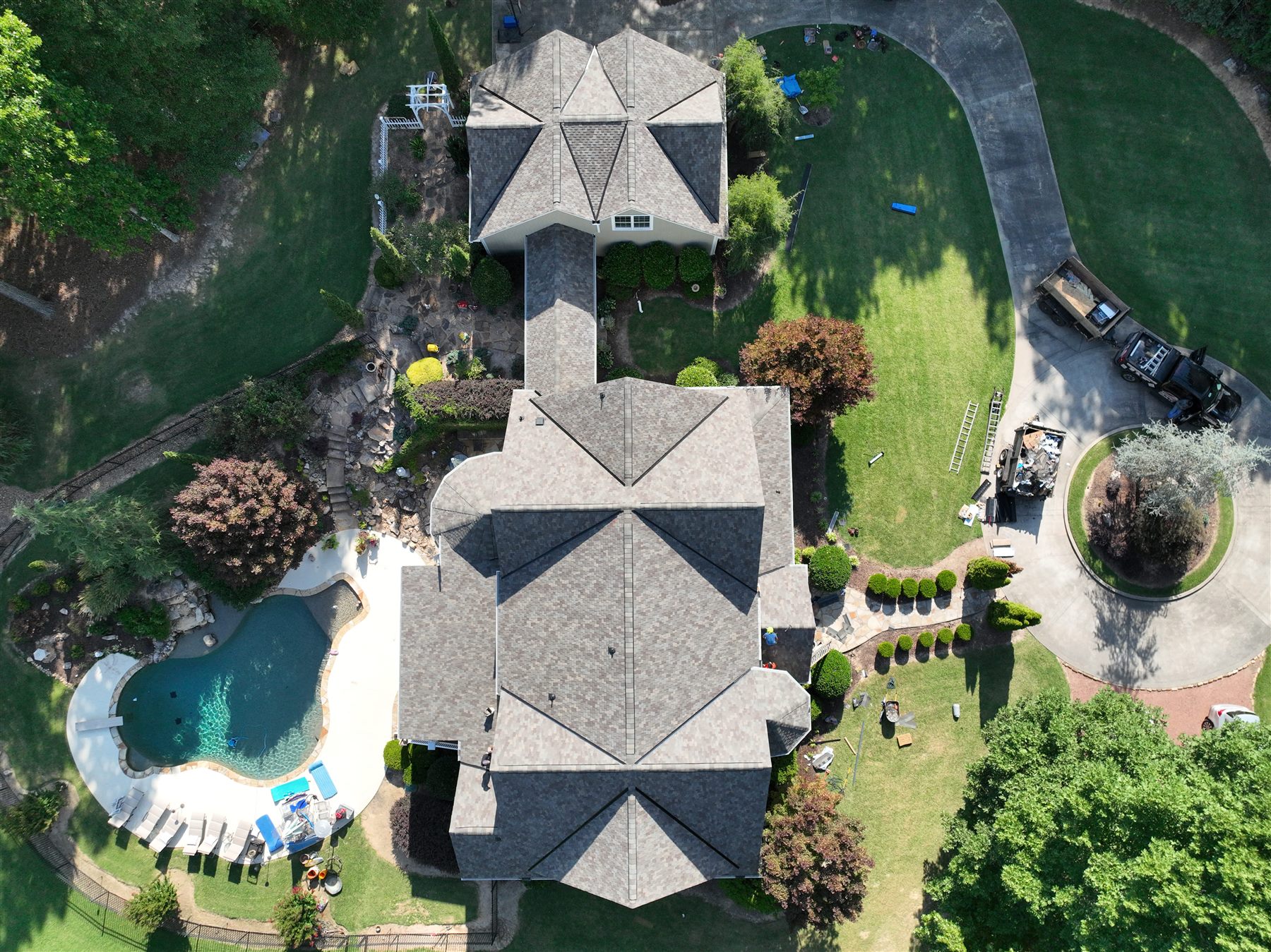 Aerial view of a residential roof and its surrounding property