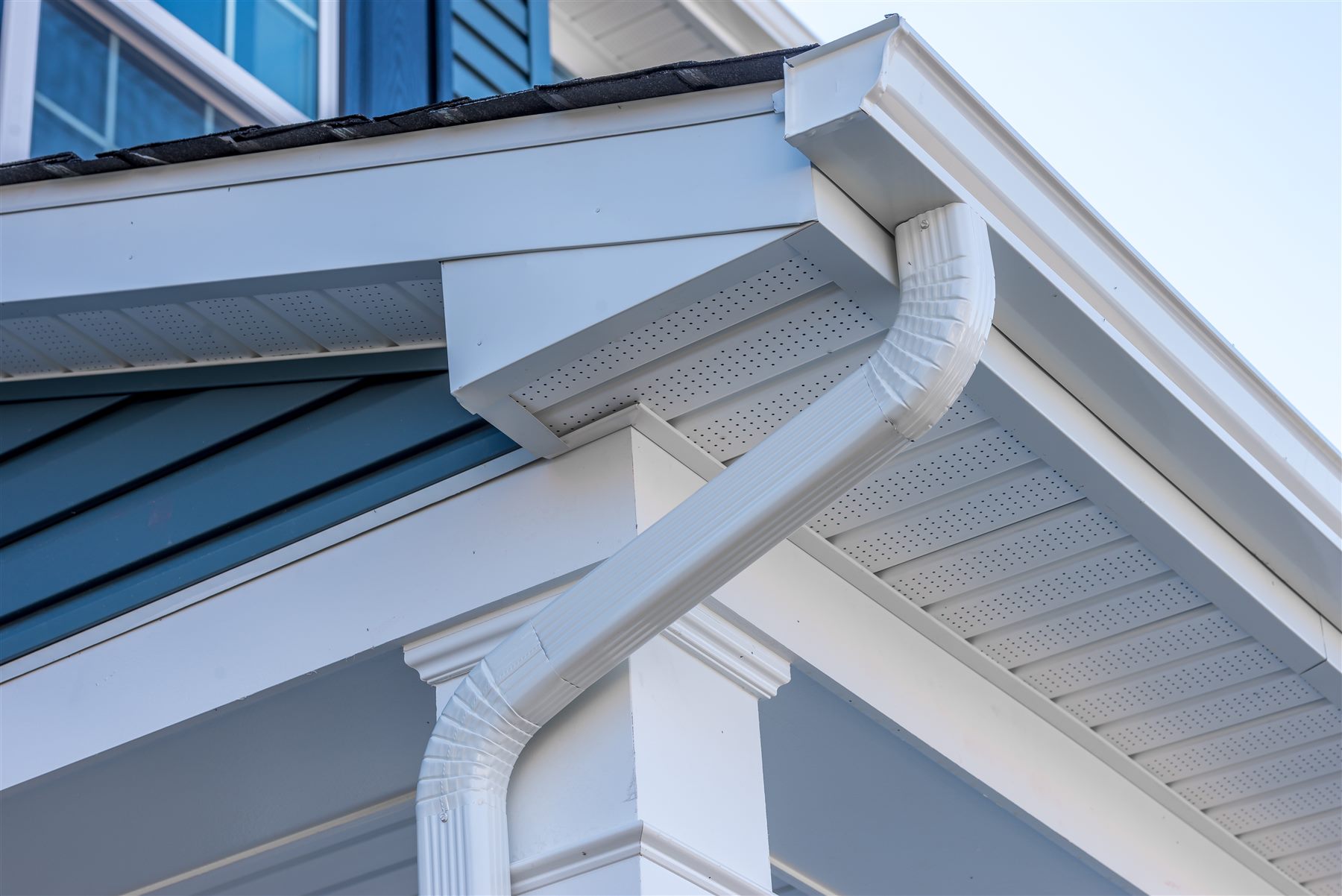Original gutter and downspout detail at a residential roofline
